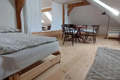a bedroom with two beds and a table and chairs at degustační dům in Babice
