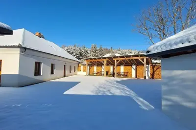 a house covered in snow with a driveway at degustační dům in Babice