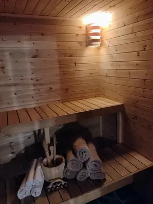 a sauna with a shelf with towels and chopsticks at Hájovna Libice in Rybníky