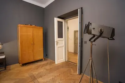 a bedroom with a bed with white sheets and a plant at Prague Days - Family-friendly Apartment with Netflix in quiet Vinohrady in Prague