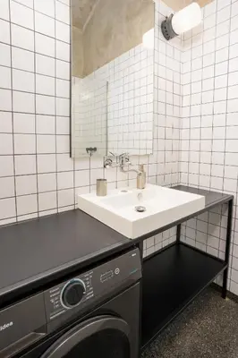 a living room with a red couch and a table at Prague Days - Family-friendly Apartment with Netflix in quiet Vinohrady in Prague