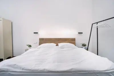 a living room with a table and a couch at Prague Days - Family-friendly Apartment with Netflix in quiet Vinohrady in Prague