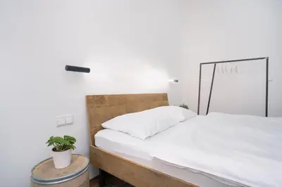 a bedroom with a desk and a bed and a window at Prague Days - Family-friendly Apartment with Netflix in quiet Vinohrady in Prague