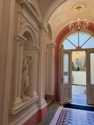 a hallway with a door and a statue of a woman at AngeloRoma Apartment in the center in Prague