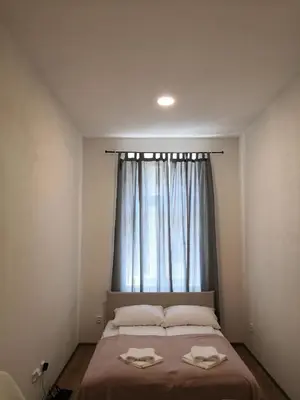 a bedroom with a bed with two towels on it at Brand New Apartments in Prague