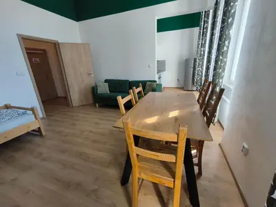 a dining room with a wooden table and chairs at Brand New Apartments in Prague