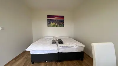 a small bedroom with a bed with two shoes on it at Apartment Golden Prague 78 in Vestec