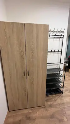 a large wooden cabinet in a room at Apartment Golden Prague 78 in Vestec