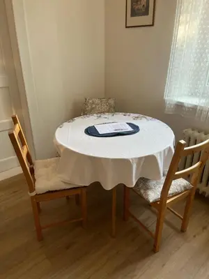 a dining room table with two chairs and a white table at Apartmán Colette in Prague