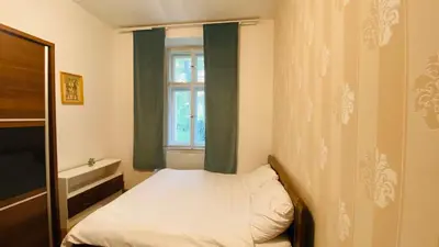 a small bedroom with a bed and a window at Hotel Apartment in square praha 2 in Prague