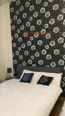 a bedroom with a bed with a black and white wall at Hotel Apartment in square praha 2 in Prague