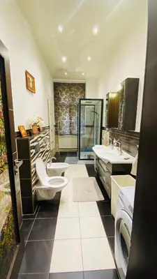 a bathroom with two sinks and two toilets at Hotel Apartment in square praha 2 in Prague