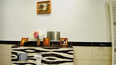 a room with a counter with pictures and flowers on it at Hotel Apartment in square praha 2 in Prague