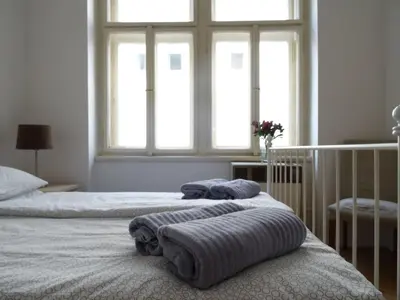 a bedroom with two beds with towels on them at Garden Apartment on Art Nouveau Street in Central Prague in Prague