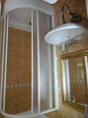 a bathroom with a white sink and a mirror at Garden Apartment on Art Nouveau Street in Central Prague in Prague
