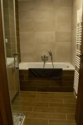 a bathroom with a bath tub with a faucet at Central Prague Vítkov - free parking in Prague