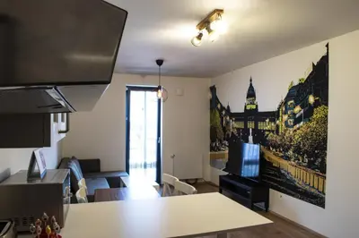 a living room with a table and a tv at Central Prague Vítkov - free parking in Prague