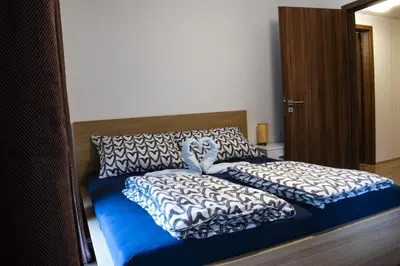 a bed with two pillows on top of it at Central Prague Vítkov - free parking in Prague