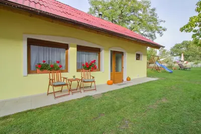 a small yellow house with a table and chairs at Domeček u Josefa in Mělník