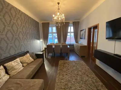 a living room with a couch and a dining room at Apartments 5 in the centre of Prague in Prague