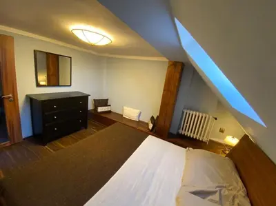 a bedroom with a bed and a dresser in a room at Apartments 5 in the centre of Prague in Prague
