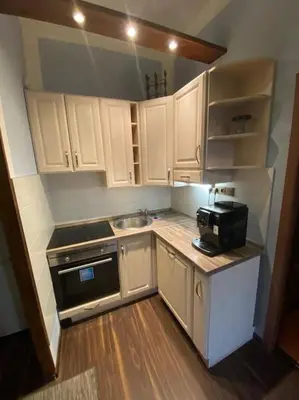 a small kitchen with white cabinets and a sink at Apartments 5 in the centre of Prague in Prague