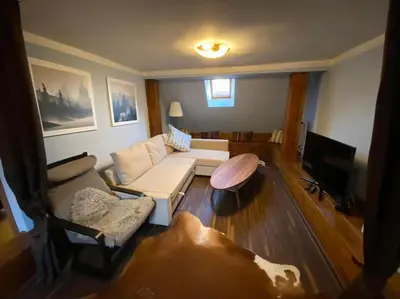 a living room with a couch and a table at Apartments 5 in the centre of Prague in Prague