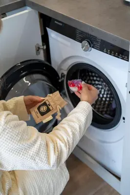 a person putting a toy in a washing machine at Aparthotel Na Klenici in Mladá Boleslav