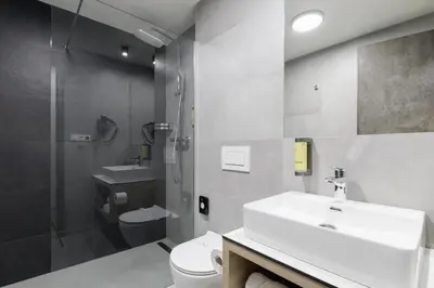 a bathroom with a sink and a toilet and a shower at Aparthotel Na Klenici in Mladá Boleslav