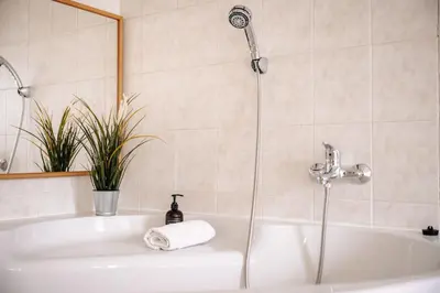 a bathroom with a bath tub with a shower at Stylish Central Duplex by Wagnerstays in Prague