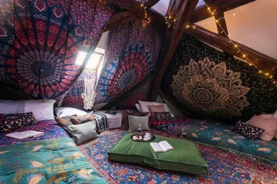 a room with a bed and a wall covered in wallpaper at Fairytale Duplex - Billiard - Whirlpool - Home Cinema - Old Town in Prague