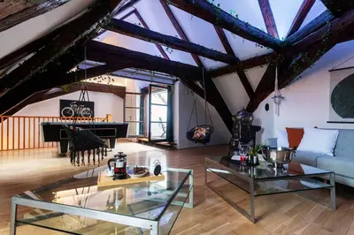 a living room with a couch and a piano at Fairytale Duplex - Billiard - Whirlpool - Home Cinema - Old Town in Prague