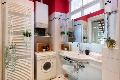 a bathroom with a washing machine and a sink at Fairytale Duplex - Billiard - Whirlpool - Home Cinema - Old Town in Prague