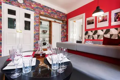 a dining room with a table with wine glasses on it at Fairytale Duplex - Billiard - Whirlpool - Home Cinema - Old Town in Prague