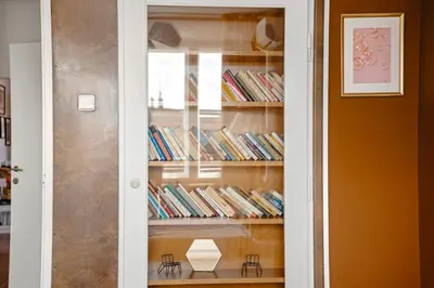 a room with a book shelf filled with books at Waterfront River Side Roof Top Apartment - Terrace with city view in Prague