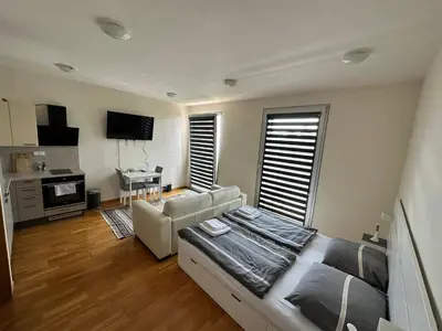 a living room with a couch and a table at Cozy apartment in Prague