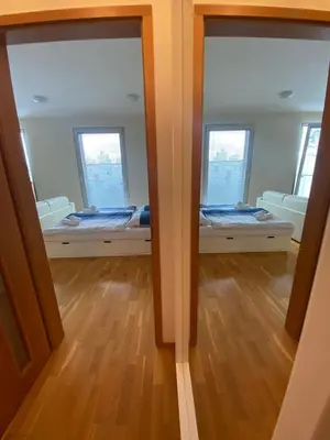 a room with two beds and two windows at Cozy apartment in Prague