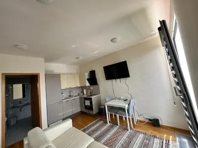 a living room with a white couch and a table at Cozy apartment in Prague