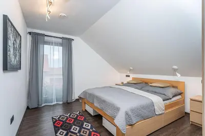 a white bedroom with a bed and a window at ESCAPE THE ORDINARY (Sauna & Jacuzzi) in Jesenice