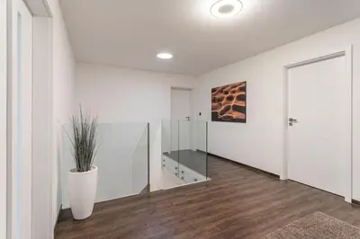 a white room with a vase with a plant in it at ESCAPE THE ORDINARY (Sauna & Jacuzzi) in Jesenice
