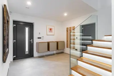 a hallway with stairs and a door in a house at ESCAPE THE ORDINARY (Sauna & Jacuzzi) in Jesenice