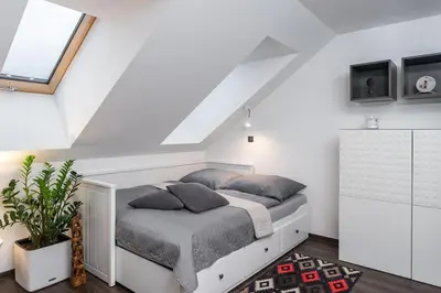 a bedroom with a bed in a attic at ESCAPE THE ORDINARY (Sauna & Jacuzzi) in Jesenice