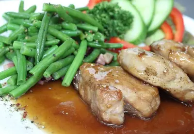 a plate of food with meat and green beans and broccoli at Ubytování u Smrku in Jeneč