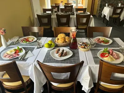 a long table with plates of food on it at Ubytování u Smrku in Jeneč