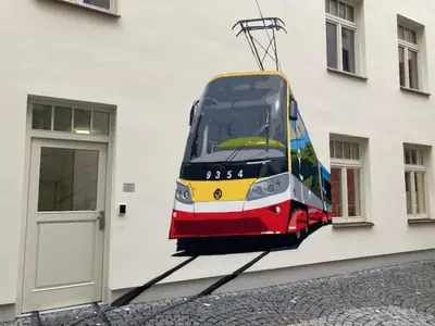 a bus is hanging on the side of a building at Capsule hostel Andel Centre SPIRIT in Prague