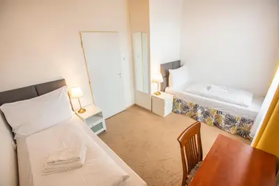 a small room with two beds and a table at Pension v parku Český Šternberk in Český Šternberk