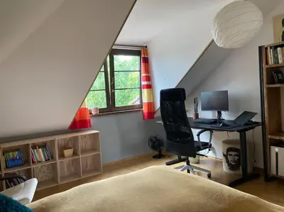 a room with a desk and a computer in a attic at Spacious villa with an outdoor pool in Černošice in Černošice