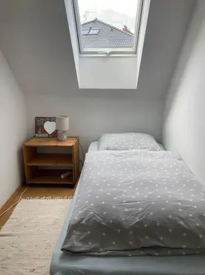 a bedroom with a bed and a window at Spacious villa with an outdoor pool in Černošice in Černošice