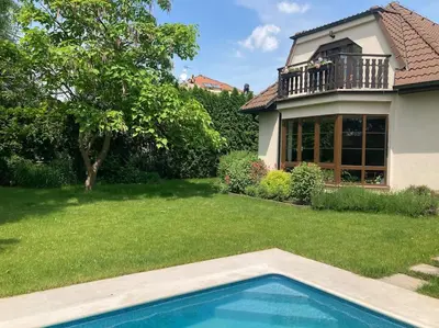 a house with a swimming pool in a yard at Spacious villa with an outdoor pool in Černošice in Černošice