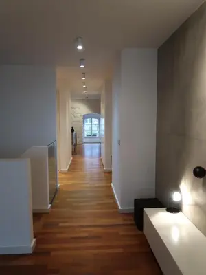 a hallway of a building with white walls and wooden floors at Michal apartment 125m2 city centre in Prague